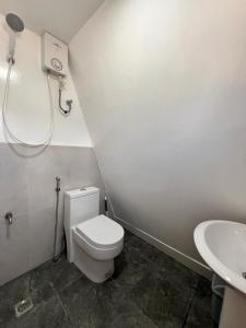 a bathroom with a toilet and a sink at Filmegs Seaside in Alegria +29 photos
