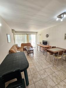 a living room with a couch and a table at Sunset on the Beach Apartment in Eretria