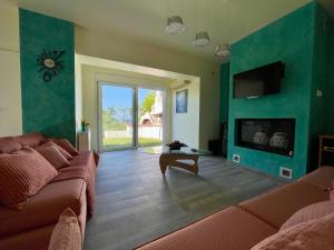 a living room with a couch and a fireplace at Jolie apartment-Panorama view in Porto Rafti
