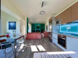 a kitchen and living room with a dining table and a fish tank at Jolie apartment-Panorama view in Porto Rafti +15 photos