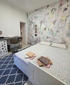a bedroom with a bed with two towels on it at AK mini studio u centru in Tivat