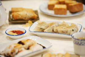 a table with plates of pastries and cups of food at The Rhyland in Flushing