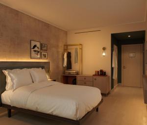 a bedroom with a large white bed and a hallway at The Rhyland in Flushing