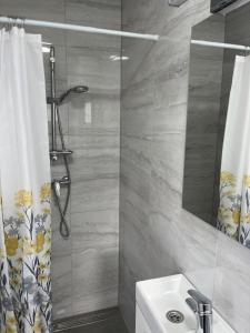a bathroom with a shower curtain and a sink at Inviting and bright 90 m2 residence with 4 balconies in Biograd na Moru
