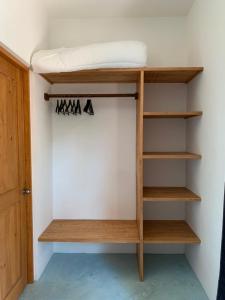 a room with a bunk bed with wooden shelves at The Jungle House, Sacbé in Playa del Carmen