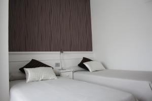 Postel nebo postele na pokoji v ubytování Hotel Herreros