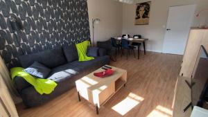 a living room with a couch and a table at Millenium Park Apartment 2-pokojowy in Gdańsk