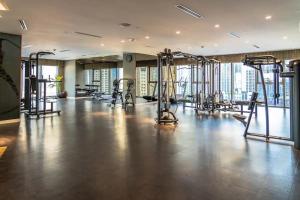 a gym with several tread machines in a room at Luxury 59th Floor Apartment with Stunning Seaview & Access to Infinity Pool on 64th Floor Burj Views in Dubai