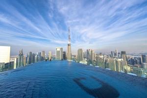 a infinity pool with a view of a city at Luxury 59th Floor Apartment with Stunning Seaview & Access to Infinity Pool on 64th Floor Burj Views in Dubai