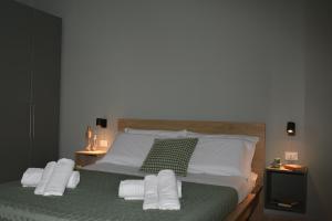 a bedroom with a bed with white pillows at WalMarhouse in Taranto