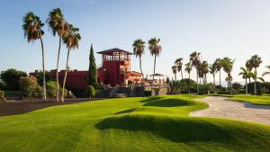 a golf course with palm trees and a tower at GORGEOUS VIEW Villa & Sauna, Golf Costa Adeje in Adeje