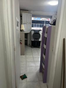 a room with a kitchen with a stove and a floor at Hostel Farol da Barra in Salvador
