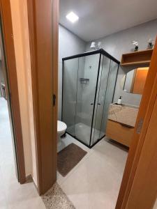 a bathroom with a glass shower and a toilet at Casa Aroeira Milagres in São Miguel dos Milagres