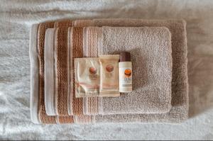 a towel with two bottles ofodorizers on a bed at Casa Il sole, vicino Deruta Assisi Perugia Monte Falco in Deruta