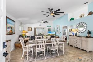 a dining room and living room with a table and chairs at Dog Friendly and STEPS from the Ocean! Big Beach House with Pool, BBQ & Garage in Chicken Island