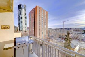 a balcony with a view of a building at Spacious Top Floor at Stampede w Free Parking and AC in Calgary