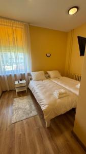 Postel nebo postele na pokoji v ubytování Apartamentai KAVA