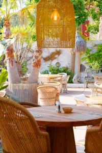 a wooden table and chairs in a patio at La Garoupe-Gardiole in Antibes