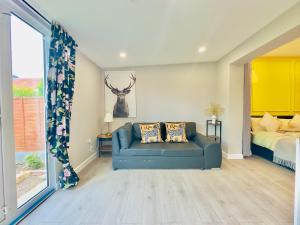 a living room with a couch and a bed at Livo Executive Suite near Bexleyheath Train in Bexleyheath