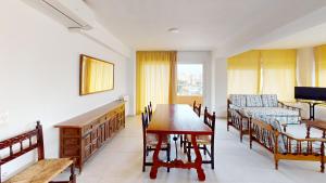 a living room with a dining room table and a couch at Apartamentos Concorde in Alicante +58 photos