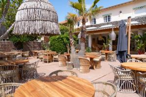 an outdoor seating area with tables and chairs at La Garoupe-Gardiole in Antibes