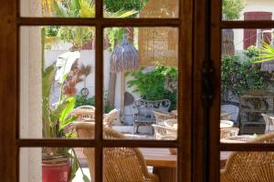 a window view of a patio with chairs and a table at La Garoupe-Gardiole in Antibes