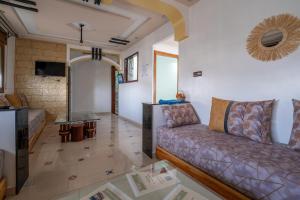 a living room with a couch and a table at Dar RADI Appart Terrace in Chefchaouen
