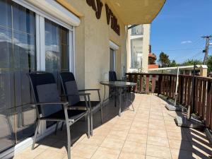 a patio with chairs and a table on a balcony at Lucky Villa in Hévíz
