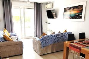 a living room with a couch and a table and a window at Ground floor family apartment, Close to Town and pool in Casas del Cura