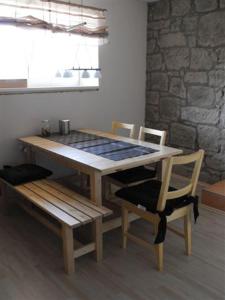 einen Tisch, zwei Stühle, einen Tisch und ein Fenster in der Unterkunft Marcos Heuboden in Oberzissen