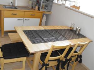 a wooden table and chairs in a kitchen at Marcos Heuboden in Oberzissen