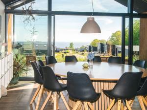 a dining room with a table and chairs at Panoramic Retreat with Pool - By Traum Ferienwohnungen in Sjølund