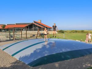 a group of people standing on top of a trampoline at 6 person holiday home on a holiday park in Sæby in Sæby