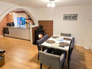 a dining room with a table and chairs and a kitchen at 8 person holiday home in Øster Assels-By Traum in Øster Assels
