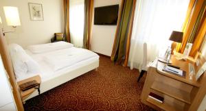 Postel nebo postele na pokoji v ubytování Apart Hotel Deutschmeister
