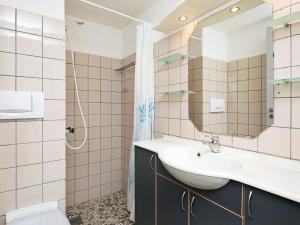 a bathroom with a sink and a mirror at Apartment with loft in Ringkøbing in Ringkøbing