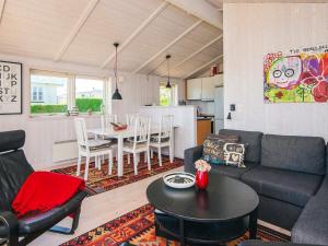 a living room with a couch and a table at 4 star holiday home in Hejls in Hejls