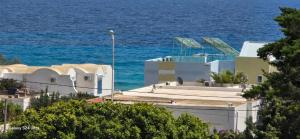 a group of white buildings with the ocean in the background at superb appartement in Kelibia