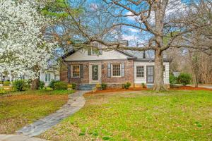 a brick house with a tree in the yard at Luxurious Retreat in Historic Downtown Burlington Downstairs Only in Burlington