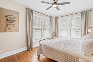 a bedroom with a bed and a ceiling fan at Luxurious Retreat in Historic Downtown Burlington Downstairs Only in Burlington
