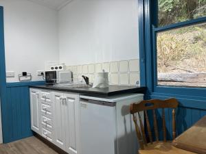 a kitchen with a sink and a counter top at School Cottage in Walhalla