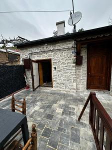 a stone building with a door and a porch at Silenos Stone House Sille Antiq City in Sille