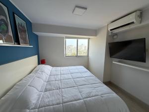 a bedroom with a bed and a flat screen tv at BR1 Barranco Exclusive Department in Lima +41 photos