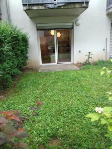 a house with a yard of grass with a window at BLR Apart in Graz