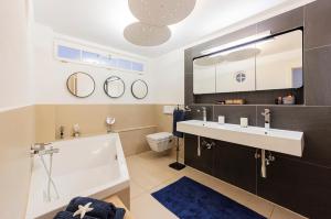 a bathroom with a sink and a toilet at 5 Sterne FeWo mit Garten und Bergblick in Chiemsee-Nähe in Übersee +43 photos