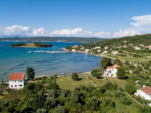 an island in the middle of a body of water at Four Bedroom Villa With Hot Tub in Pašman