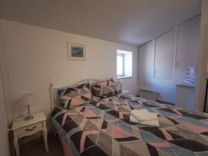 a bedroom with a bed and a table with a lamp at Sea View Holiday Home Umag - Three Bedroom Holiday Home in Umag