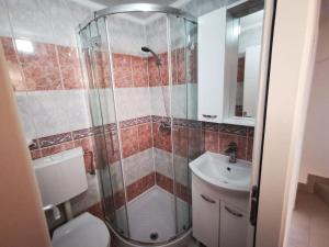 a bathroom with a shower and a toilet and a sink at Sea View Holiday Home Umag - Three Bedroom Holiday Home in Umag +34 photos