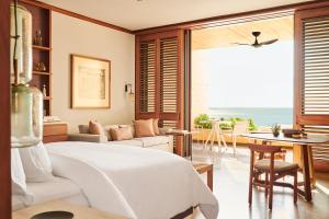 a bedroom with a bed and a view of the ocean at Four Seasons Resort Tamarindo, México in Cihuatlán