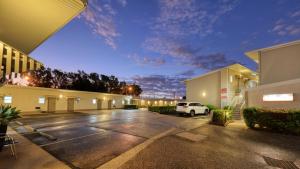 a parking lot in front of a building at Route 66 Motor Inn in Emerald +50 photos